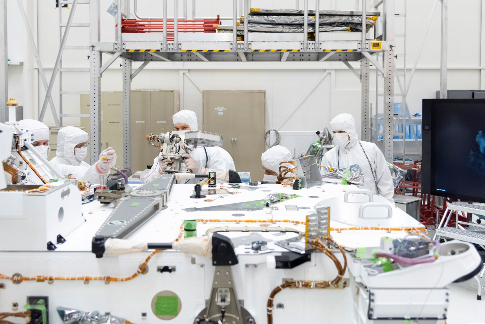 Mars 2020 engineers and technicians installed the high-gain antenna on the rover's equipment deck in the Spacecraft Assembly Facility's High Bay 1 clean room at JPL.