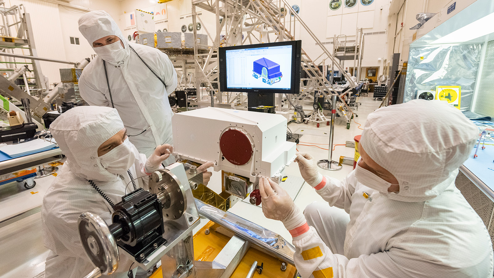 Technicians install a Mastcam-Z high-definition camera in the remote sensing mast that will later go on NASA's Mars 2020 rover.