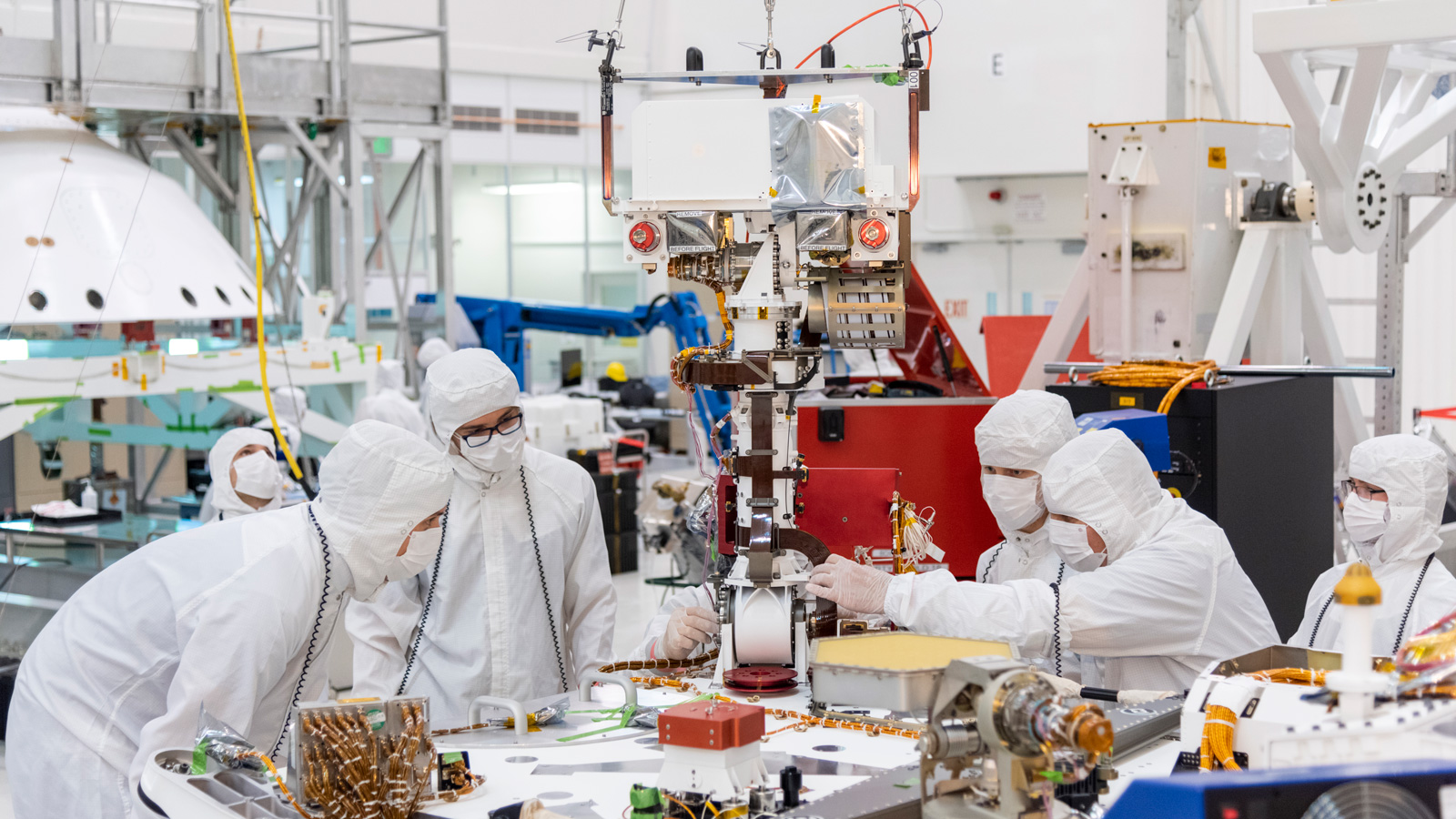 Engineers and technicians at NASA's Jet Propulsion Laboratory in Pasadena, California, install the remote sensing mast on the Mars 2020 rover.