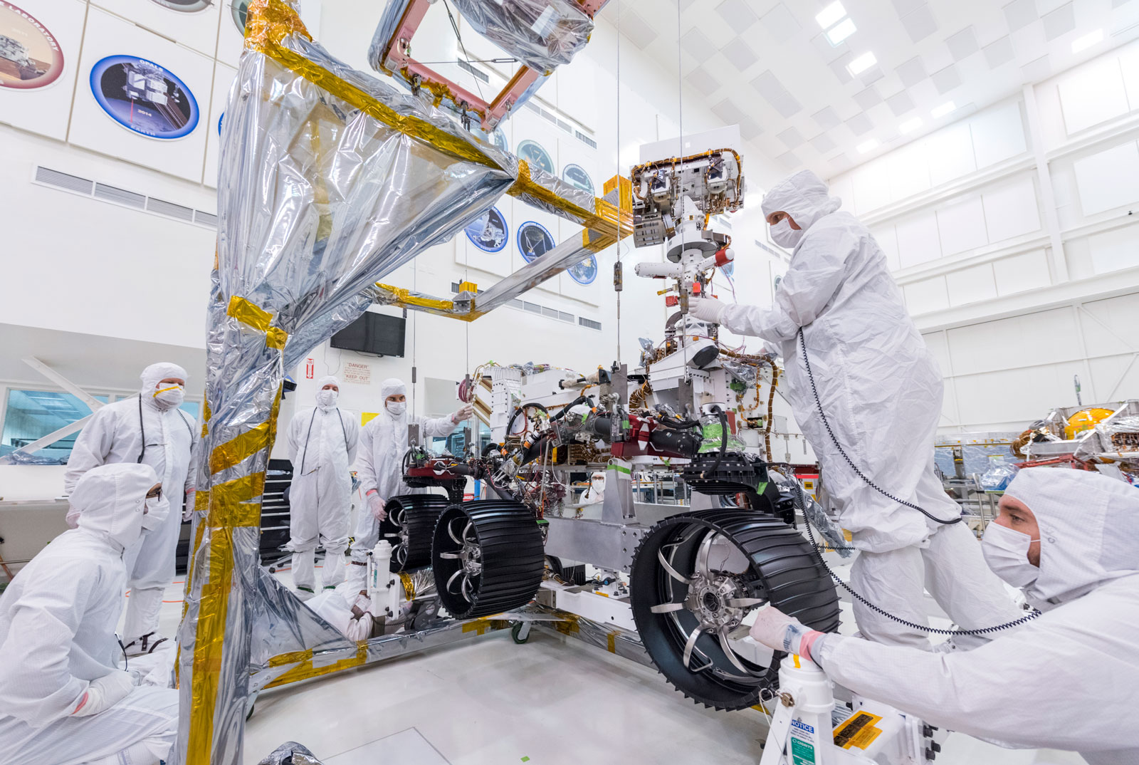 In this image, taken on June 13, 2019, engineers at JPL install the starboard legs and wheels — otherwise known as the mobility suspension — on the Mars 2020 rover.