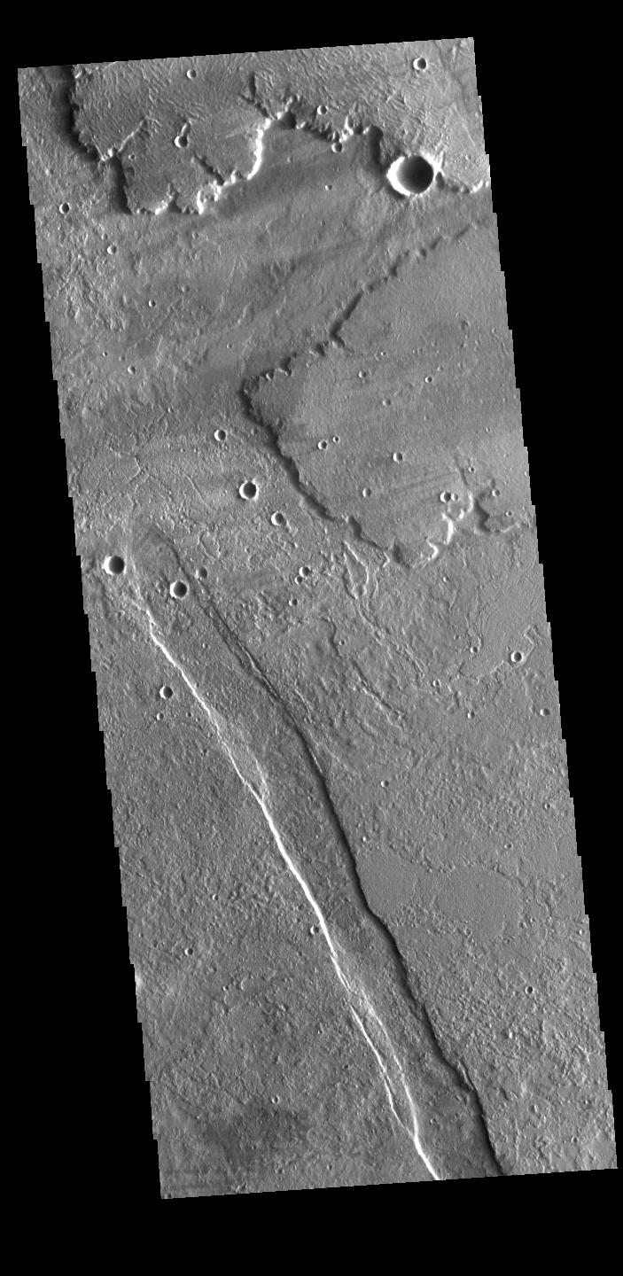 This image from NASAs Mars Odyssey shows lava flows from Alba Mons, and a tectonic graben called Cyane Fossae.