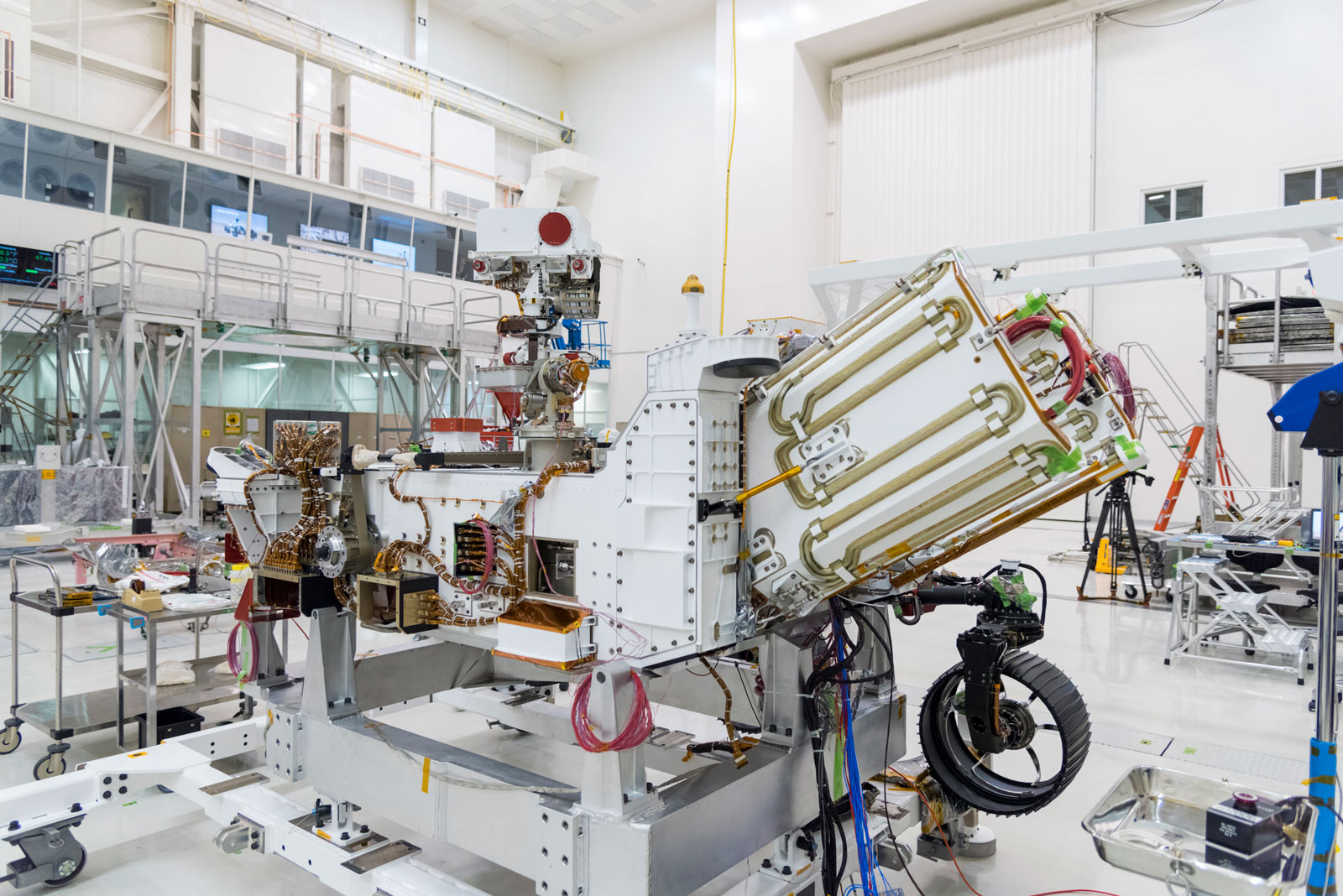The electricity for NASA's Mars 2020 rover is provided by a power system called a Multi-Mission Radioisotope Thermoelectric Generator, or MMRTG. The MMRTG will be inserted into the aft end of the rover between the panels with gold tubing visible at the rear, which are called heat exchangers.