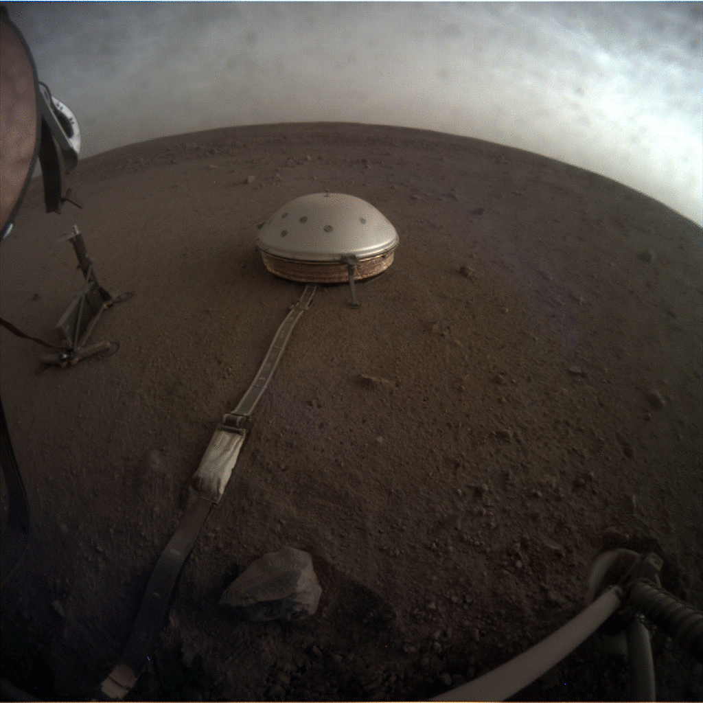Clouds drift over the dome-covered seismometer, known as SEIS, belonging to NASA's InSight lander, on Mars.