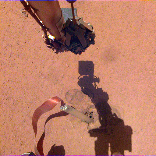 The shadow of NASA InSight's robotic arm moves over its heat probe, or "mole," on Nov. 3, 2019, the 333rd Martian day, or sol, of the mission.