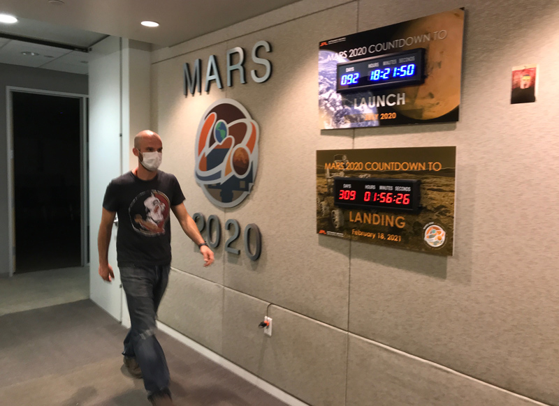 Countdown to Launch: Ian Clark walks past mission countdown clocks in the Perseverance offices at NASA's JPL.