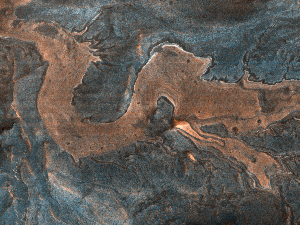 Part of the canyon floor and wall rock in southwestern Melas Chasma on Mars meanders in a pattern resembling a dragon.