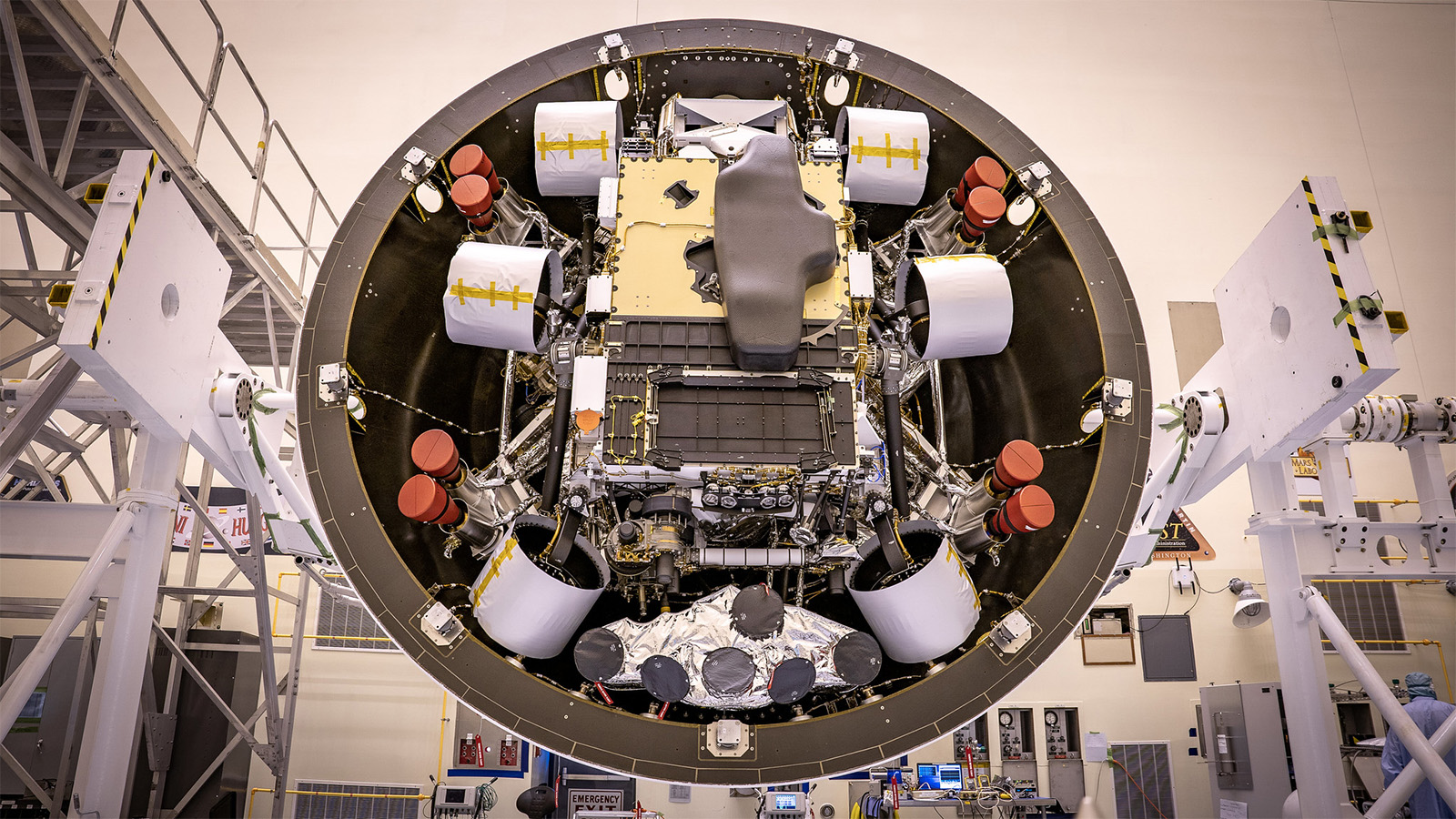 In the Payload Hazardous Servicing Facility at Kennedy Space Center in Florida, the Backshell-Powered Descent Vehicle and Entry Vehicle assemblies are being prepared to be attached to the Perseverance rover on May 4, 2020.