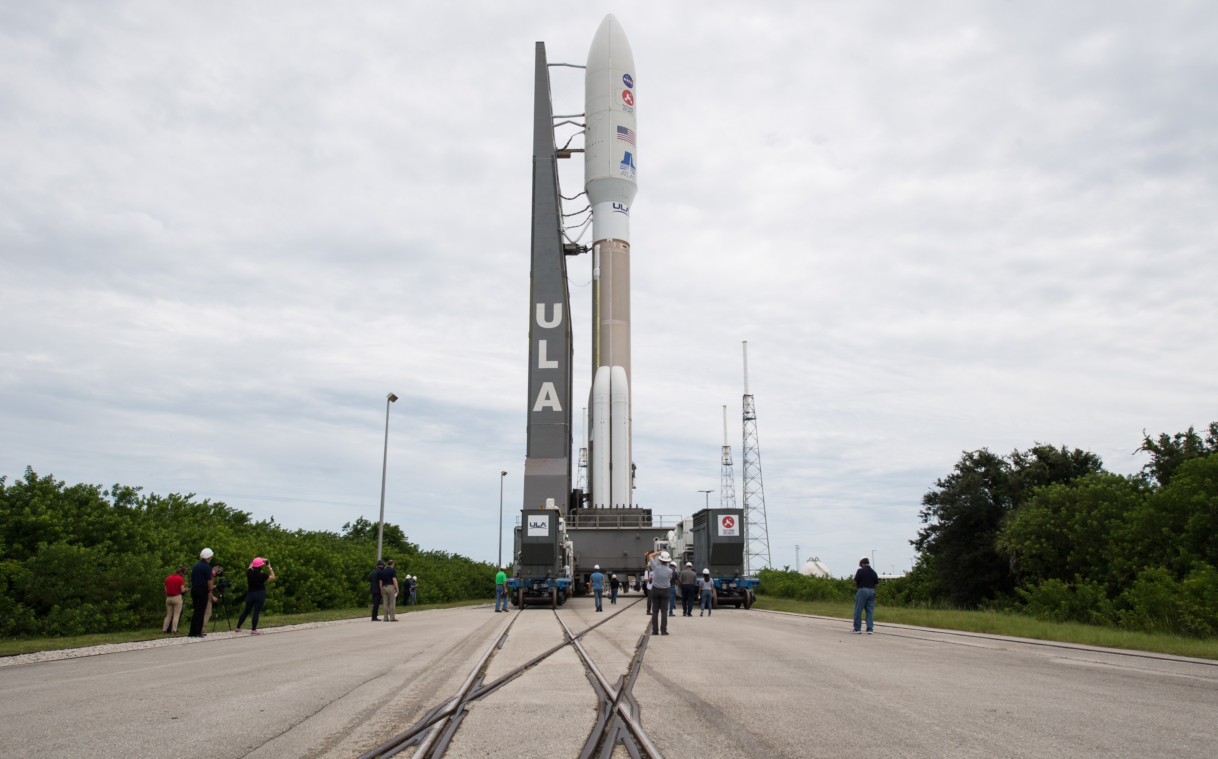 The rocket carrying Perseverance is seen as it is rolled out of the Vertical Integration Facility to the launch pad at Space Launch