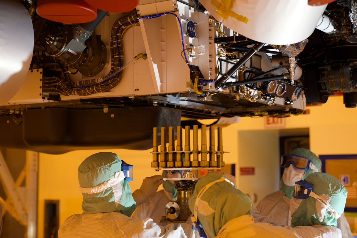 A tray holding 39 sample tubes – each protected in a gold-colored sheath – is installed in NASA's Perseverance rover in this picture taken at the agency's Kennedy Space Center on May 21, 2020.