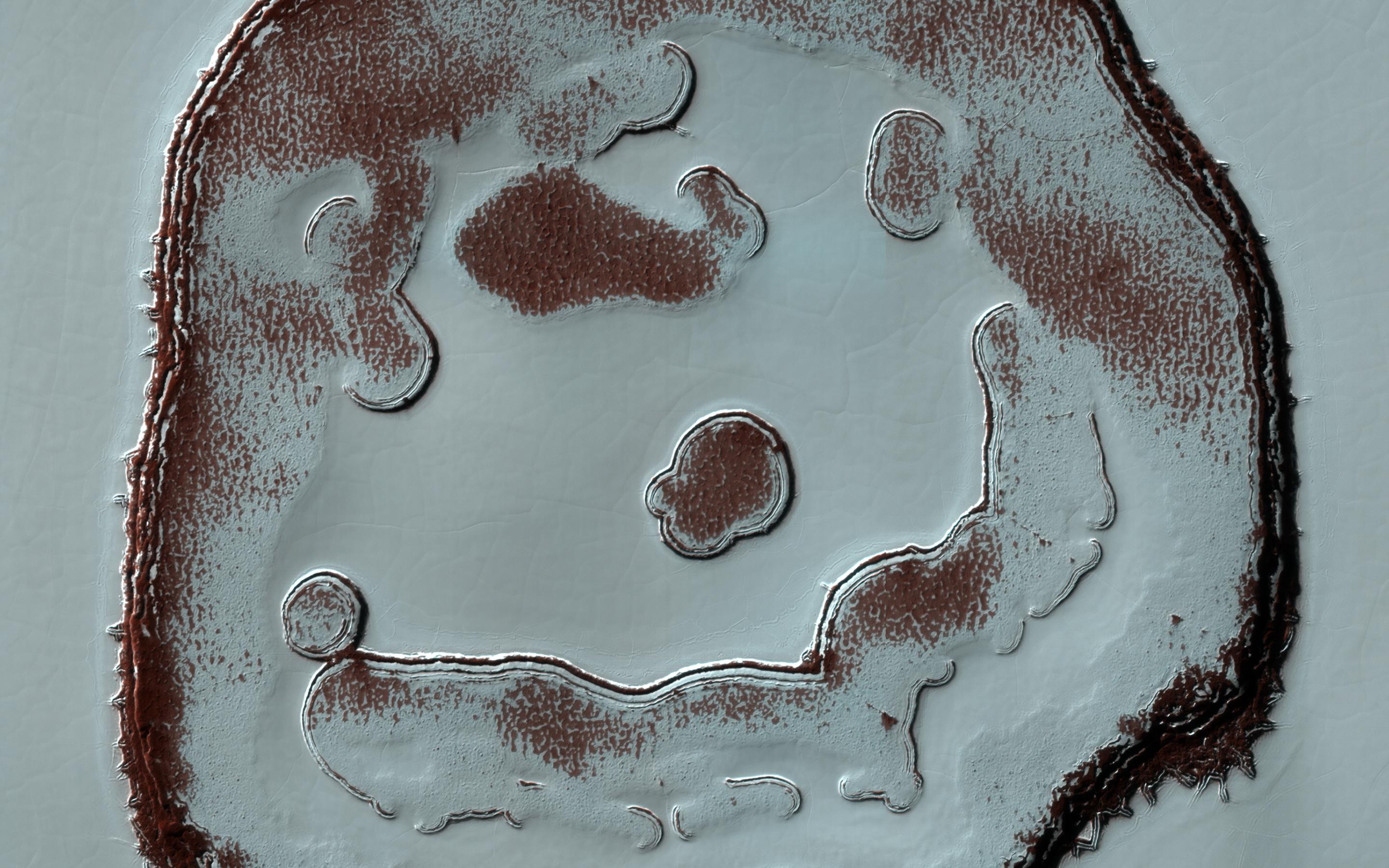 This image acquired on December 13, 2020 by NASAs Mars Reconnaissance Orbiter, shows blobby features in the polar cap that are due to the sun sublimating away the carbon dioxide into these round patterns.