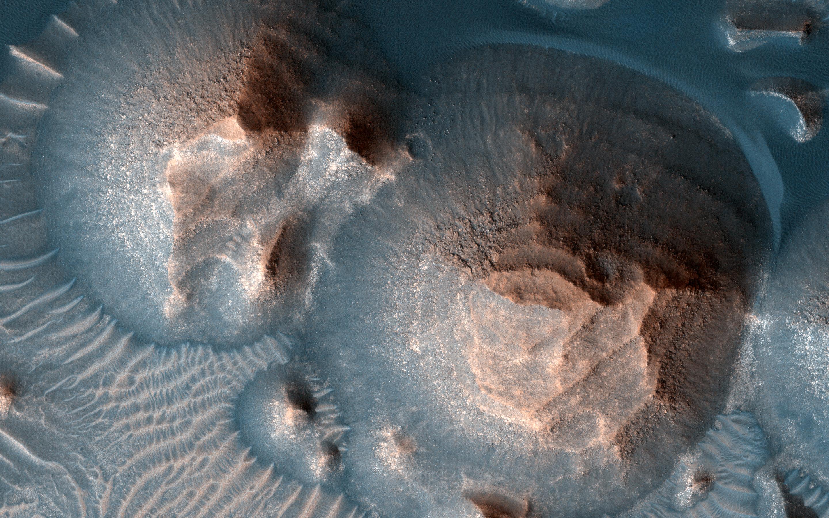 This image acquired on October 1, 2020 by NASAs Mars Reconnaissance Orbiter, shows several craters in Arabia Terra filled with layered rock.
