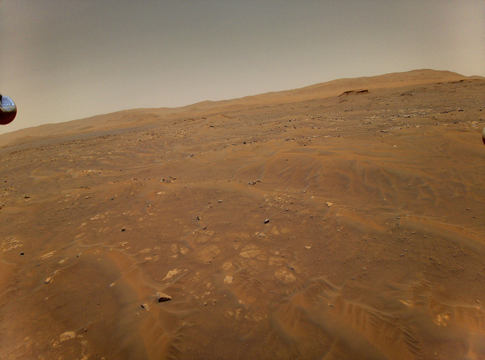 This image looking west toward the Séítah geologic unit on Mars was taken from the height of 33 feet (10 meters) by NASA’s Ingenuity Mars helicopter during its sixth flight, on May 22, 2021.