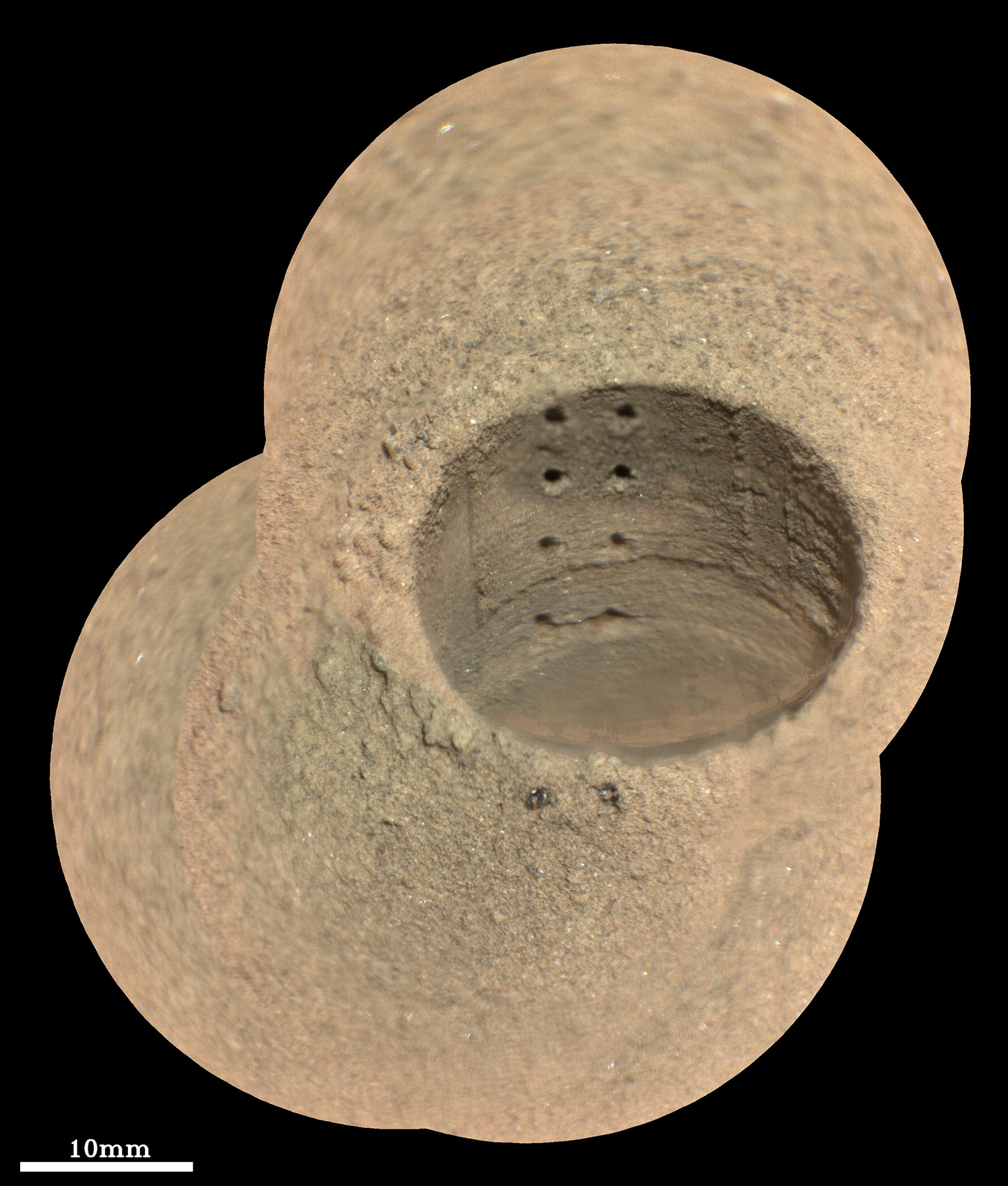 This composite image, made from four taken by the SuperCam instrument aboard NASA’s Perseverance rover on Aug. 8, 2021, shows the hole in a Martian rock where the rover attempted to collect its first sample; the small pits within it were created by laser zaps from SuperCam.