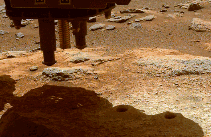 An animated GIF depicts the Martian surface below the Perseverance rover, showing the results of the Jan. 15, 2022, percussive drill test to clear cored-rock fragments from one of the rover’s sample tubes.