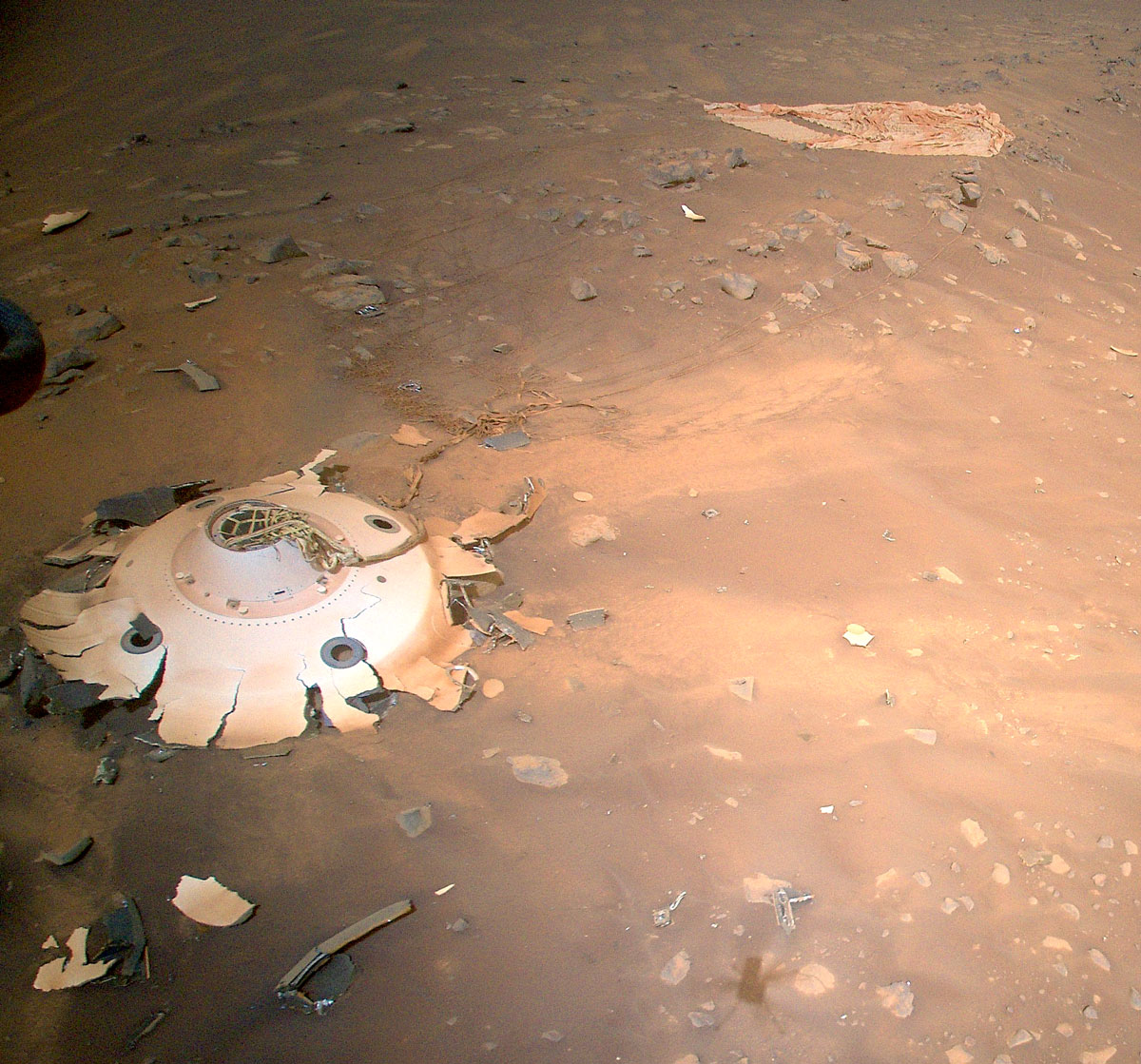 This image of the backshell and supersonic parachute of NASA’s Perseverance rover was captured by the agency’s Ingenuity Mars Helicopter during its 26th flight on Mars on April 19, 2022.