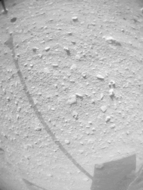 A small piece of foreign object debris (FOD) is seen in footage from the navigation camera of NASA's Ingenuity Mars Helicopter during its 33rd flight on Mars on Sept 24, 2022. The FOD is seen attached to one of the rotorcraft's landing legs, then drifting away.