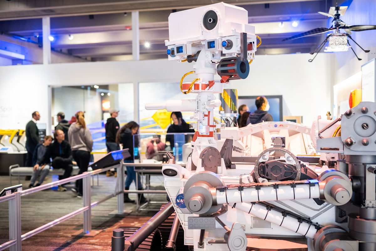Members of the public interact with life-size models of the Perseverance rover and Ingenuity Mars helicopter during an exhibit at the Museum of Science in Boston, as part of the Roving With Perseverance road show.