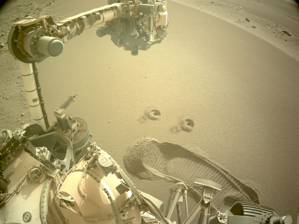 Two holes are left in the Martian surface after NASA’s Perseverance rover used a specialized drill bit to collect the mission’s first samples of regolith – broken rock and dust – on Dec. 2 and 6.