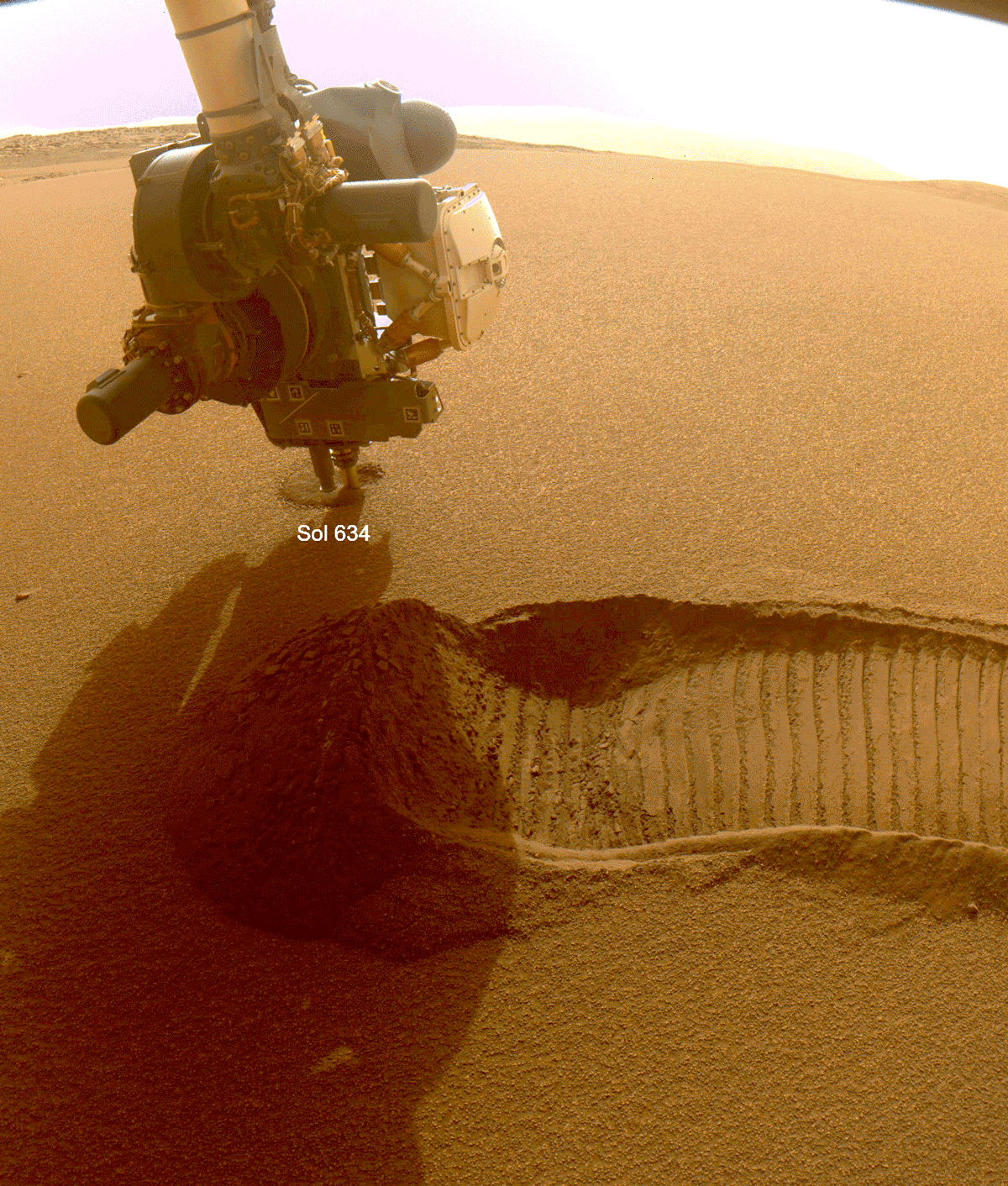 This GIF shows NASA’s Perseverance Mars rover collecting two samples of regolith – broken rock and dust – with a regolith sampling bit on the end of its robotic arm.
