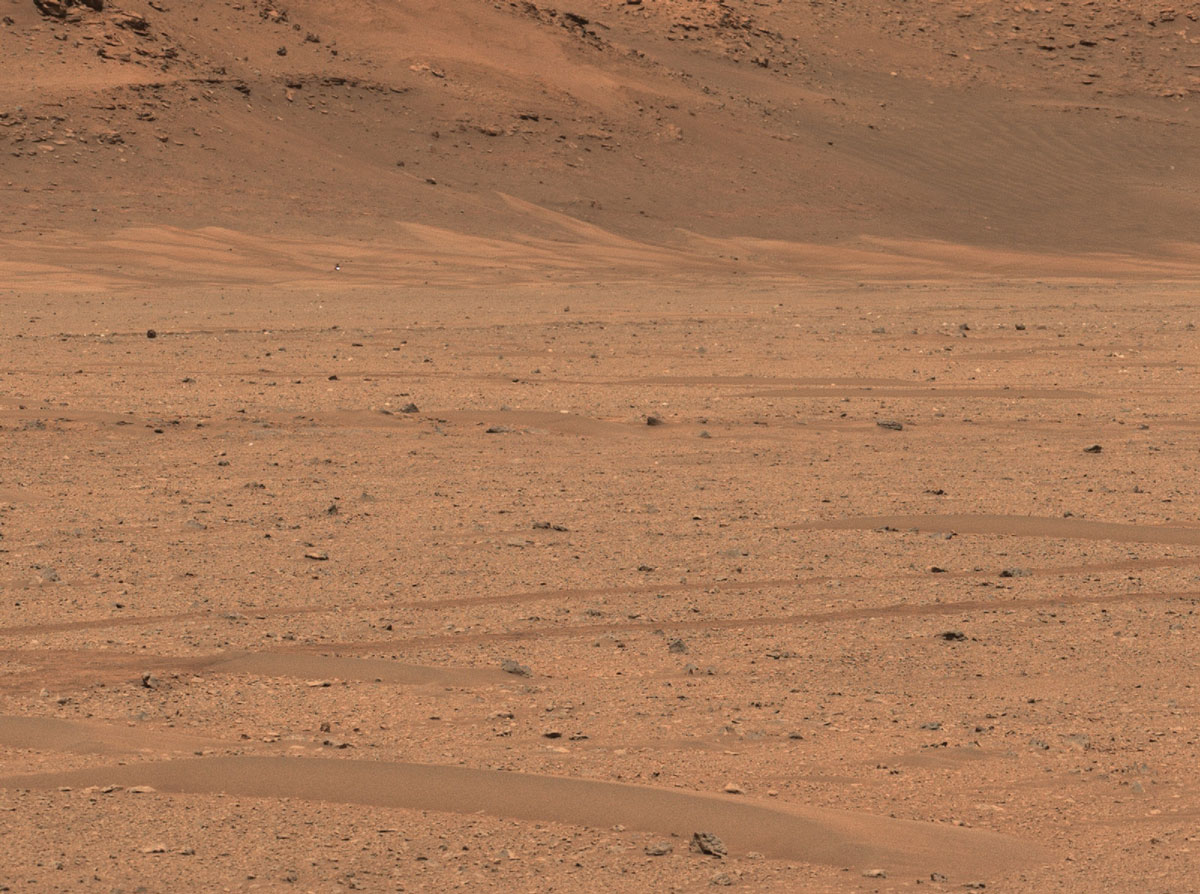 NASA’s Perseverance Mars rover captured the agency’s Ingenuity Mars Helicopter in the distance, near the base of Jezero Crater’s river delta, in this image taken Dec. 18, 2022, the 650th day, or sol, of the mission.