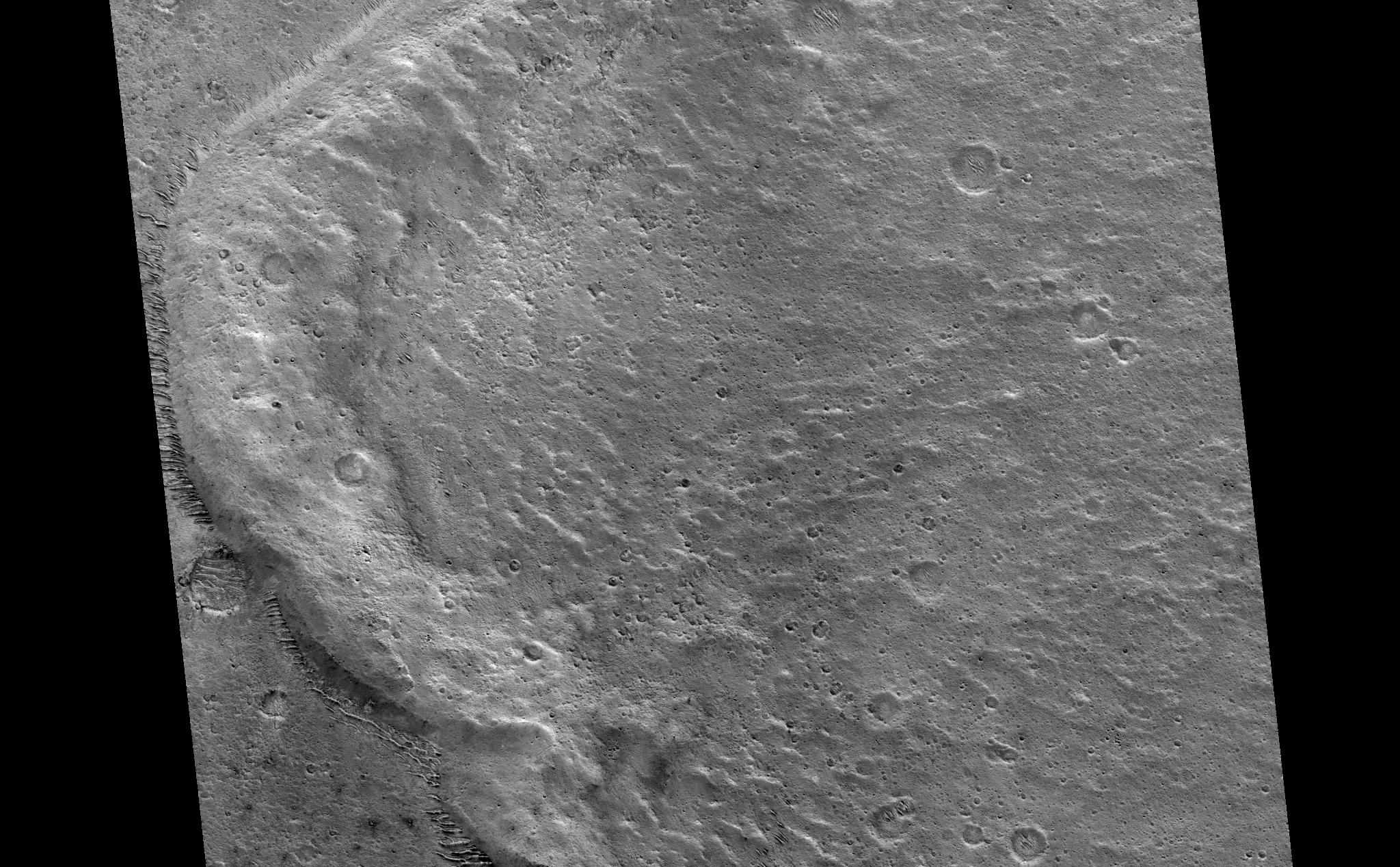 Impact craters on Mars are kind of neat. Many of them look very different than impact craters seen on Earth's moon or Mercury. Fresh lunar and Mercurian craters have ejecta blankets that look a bit rough near the crater rims; around larger craters, long rays or chains of secondary craters radiate away from the crater rims. Some Martian craters are similar to these craters, but Mars also has a high proportion of craters with forms not found on the moon or Mercury: rampart craters.