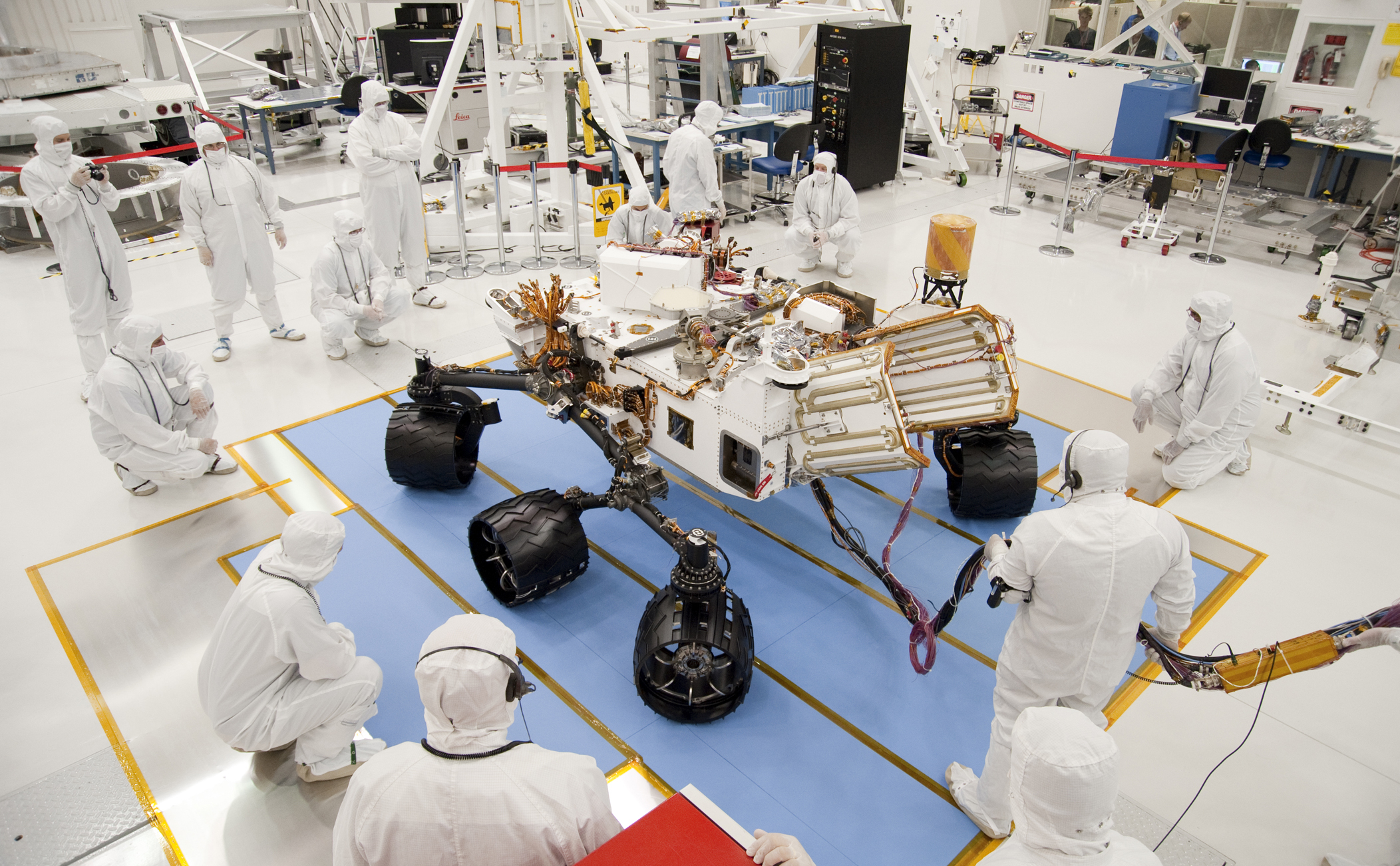 Technicians and engineers in clean-room garb monitor the first drive test of NASA's Curiosity rover, on July 23, 2010.