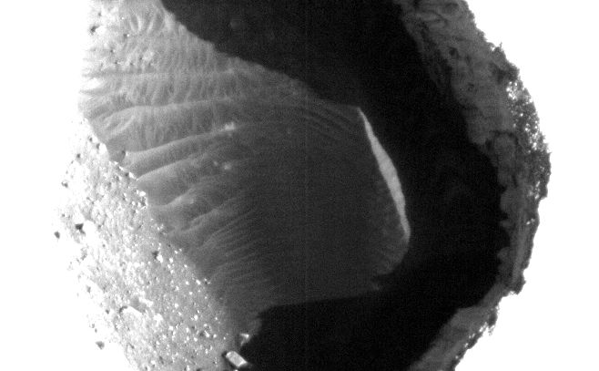 This enhanced image shows the inside of a rimless pit about 180 meters (591 feet) in diameter, northwest of the mountain Ascraeus Mons in the northern hemisphere of Mars.