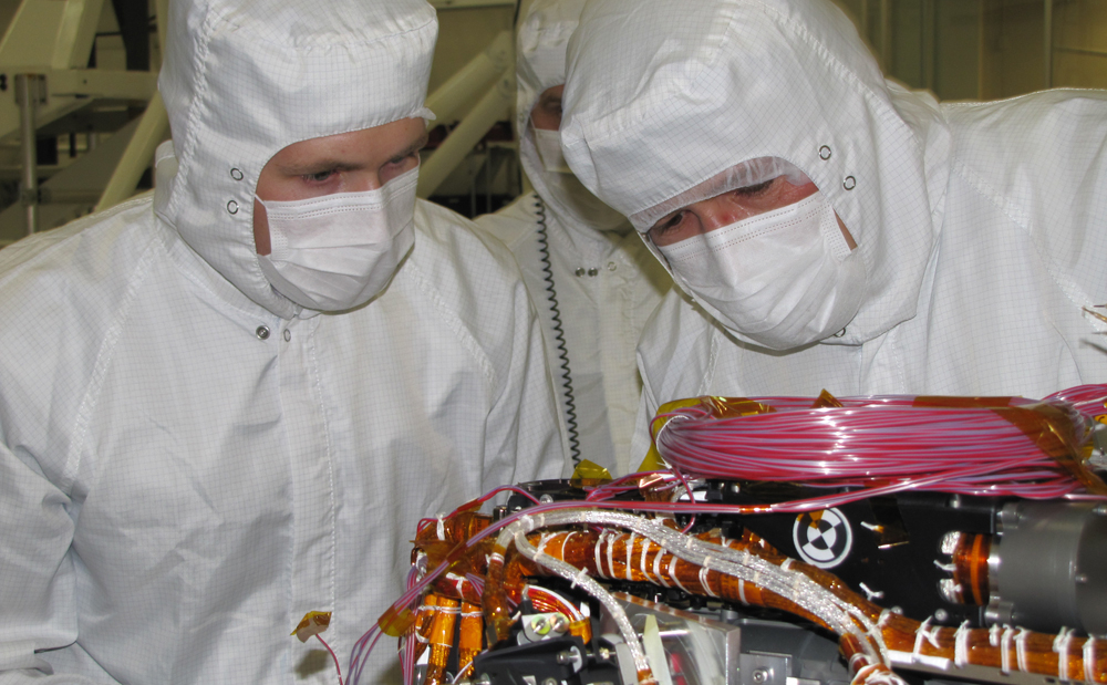Grad student Nicholas Boyd (left) and Principal Investigator Ralf Gellert, both of the University of Guelph, Ontario, Canada, prepare for the installation of the Alpha Particle X-ray Spectrometer sensor head during testing at NASA's Jet Propulsion Laboratory.