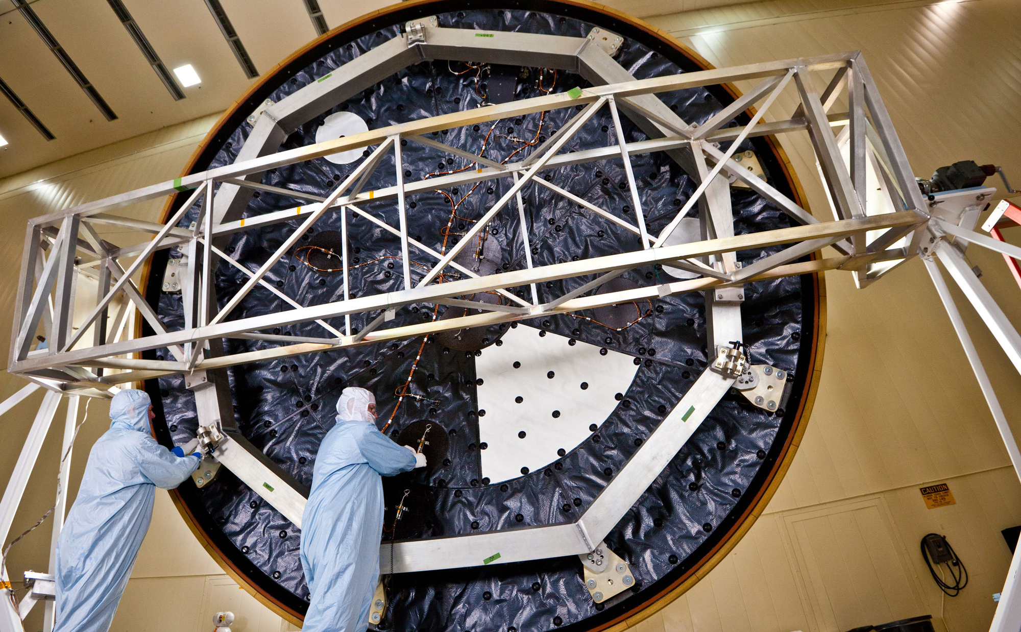 Technicians at Lockheed Martin Space Systems, Denver, prepare the heat shield for NASA's Mars Science Laboratory, in this April 2011 photo. With a diameter of 4.5 meters (nearly 15 feet), this heat shield is the largest ever built for a planetary mission.
