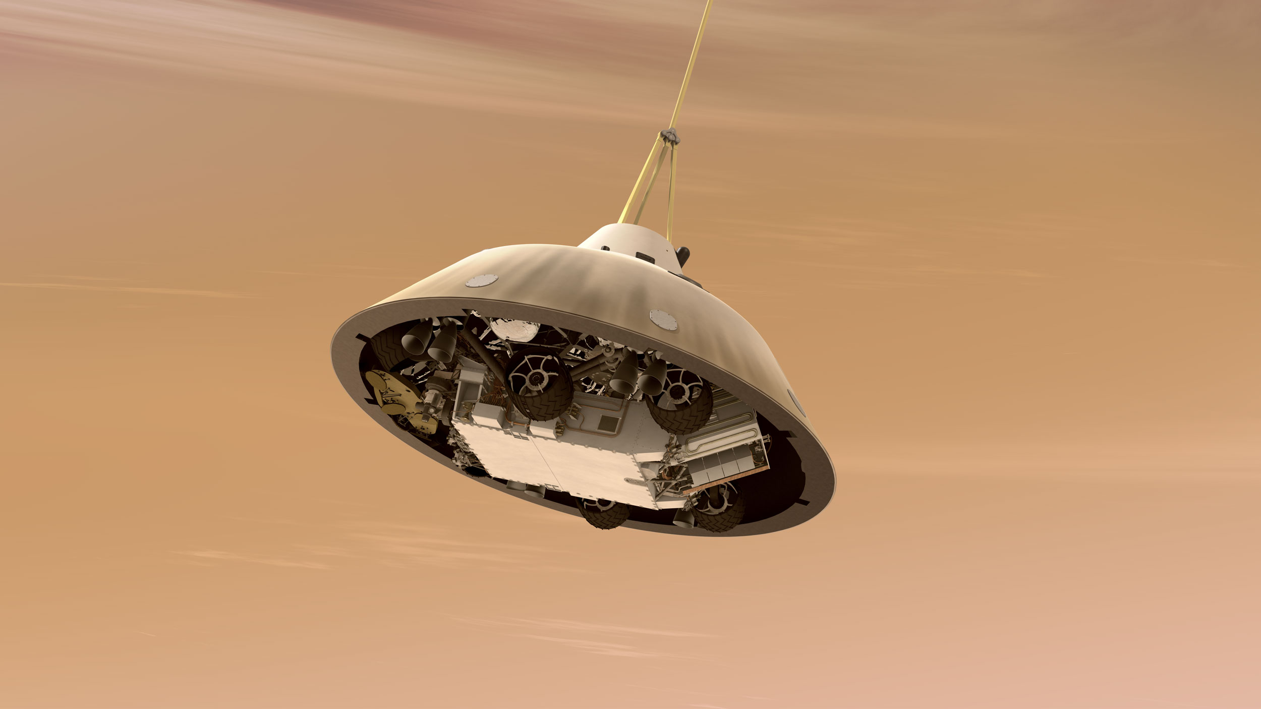 This is an artist's concept of NASA's Curiosity rover tucked inside the Mars Science Laboratory spacecraft's backshell while the spacecraft is descending on a parachute toward Mars.