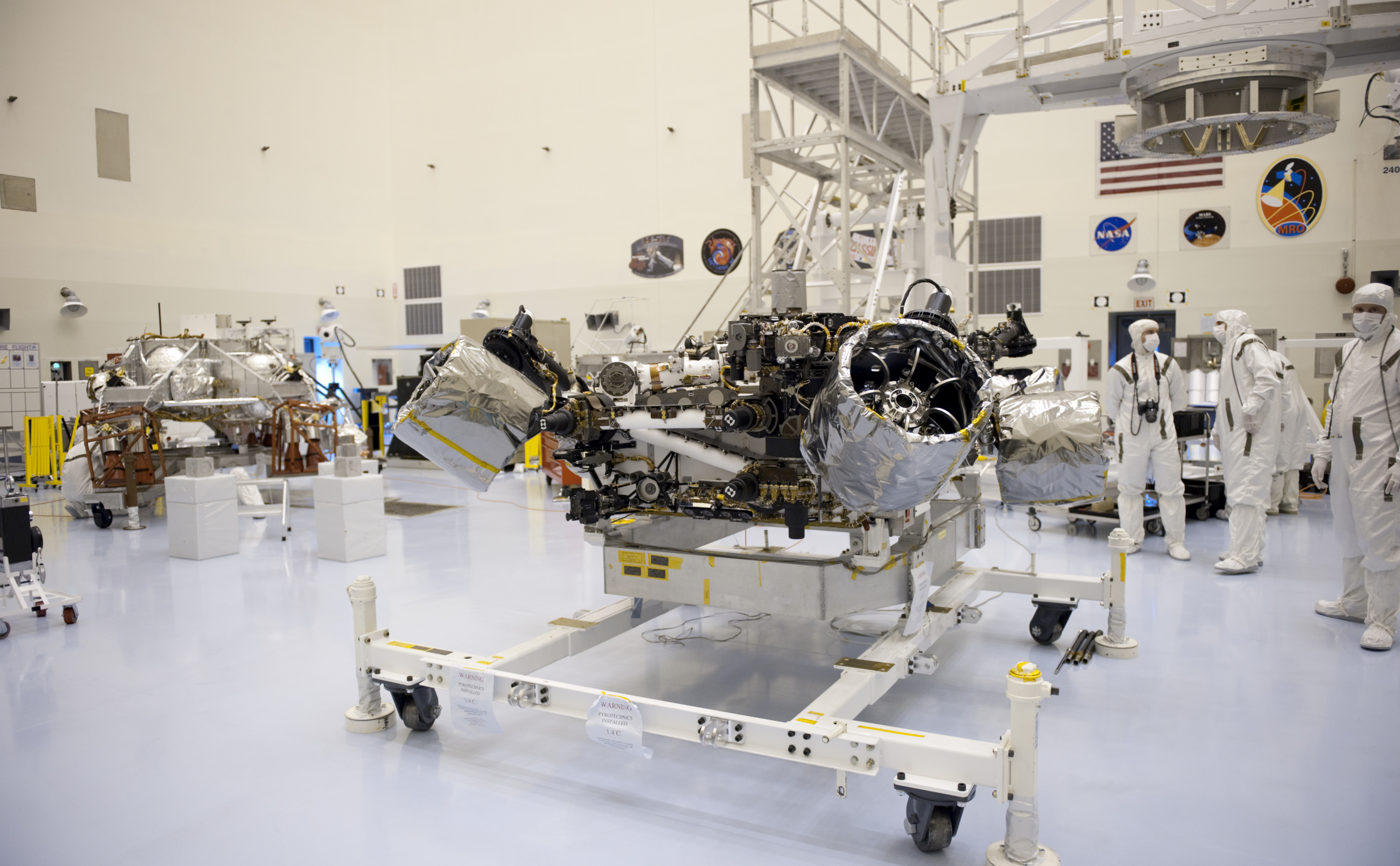At the Payload Hazardous Servicing Facility at NASA's Kennedy Space Center in Florida, NASA's Mars Science Laboratory (MSL) rover, known as Curiosity, will be integrated with a rocket-powered descent stage (shown here to the left of the rover).