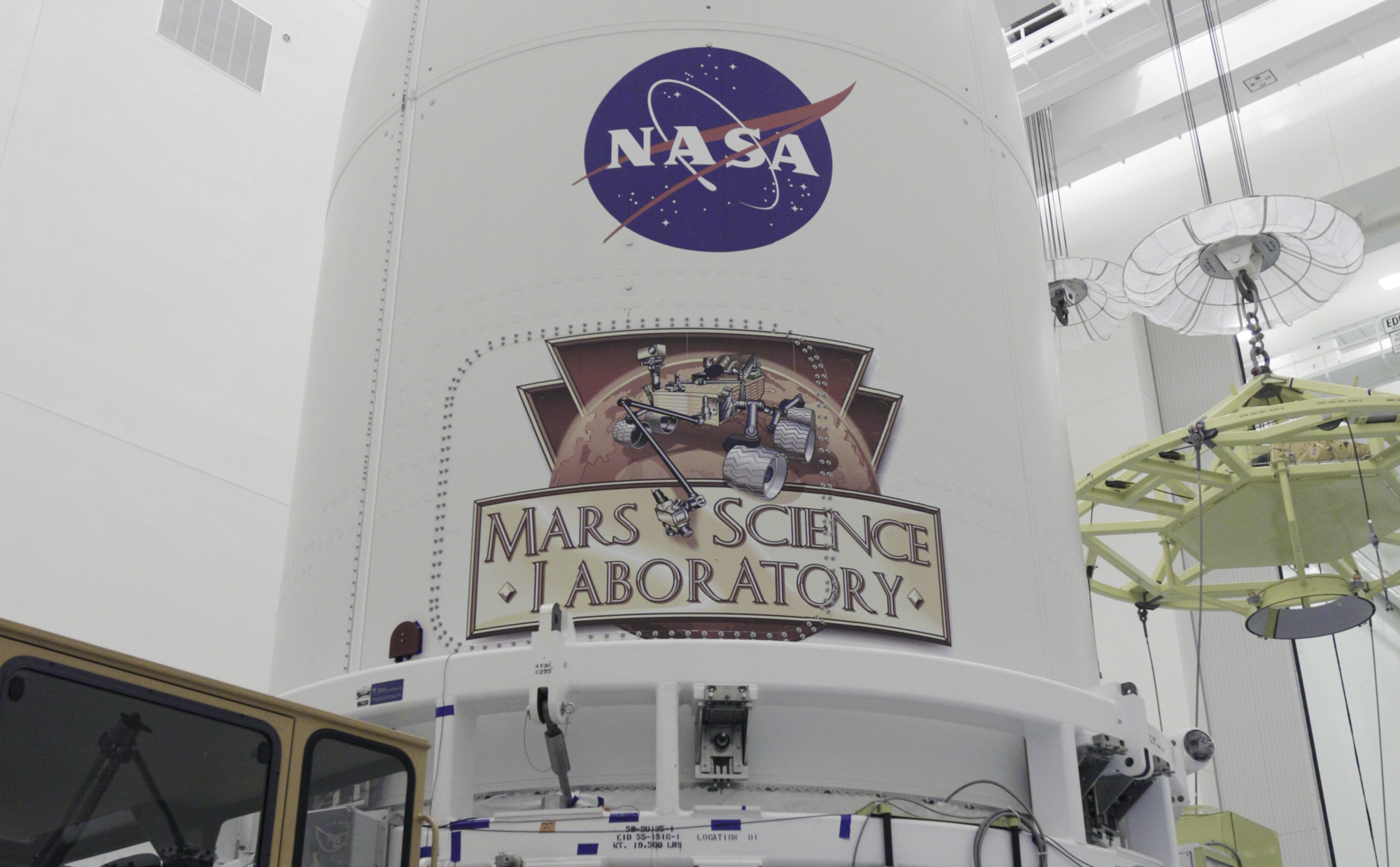 In the Payload Hazardous Servicing Facility at NASA's Kennedy Space Center in Florida, the Atlas V rocket's payload fairing containing the Mars Science Laboratory (MSL) spacecraft stands securely atop the transporter that will carry it to Space Launch Complex 41.
