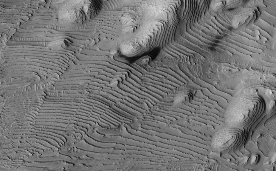 Rhythmic patterns of sedimentary layering in Danielson Crater on Mars result from periodic changes in climate related to changes in tilt of the planet.