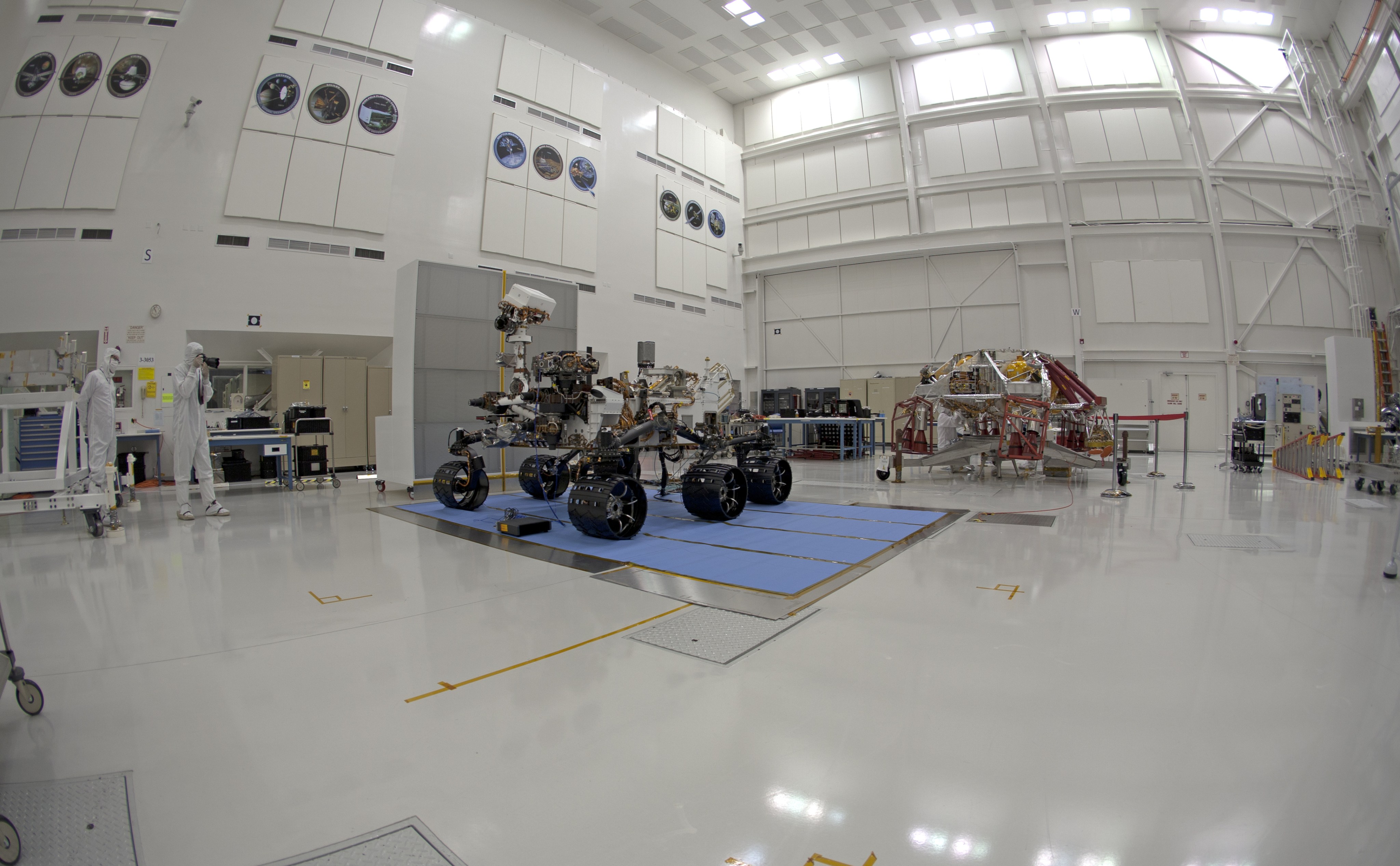 NASA's Curiosity rover and its powered descent vehicle pose for photographs prior to being integrated for launch at JPL's Spacecraft Assembly Facility.