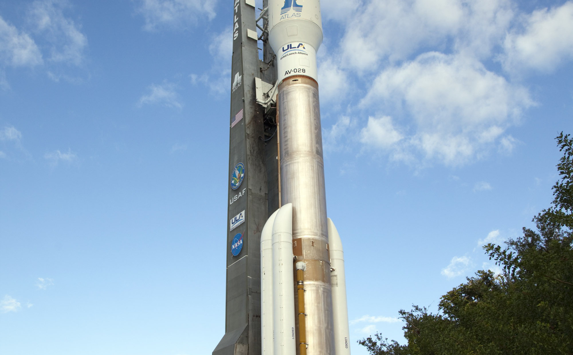 On Cape Canaveral Air Force Station in Florida, the 197-foot-tall United Launch Alliance Atlas V rocket rolls to the launch pad at Space Launch Complex 41.