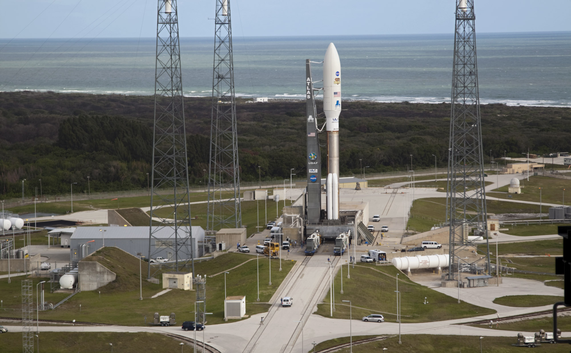 On Cape Canaveral Air Force Station in Florida, the 197-foot-tall United Launch Alliance Atlas V rocket is in place at Space Launch Complex 41 after rolling out from the nearby Vertical Integration Facility (VIF).