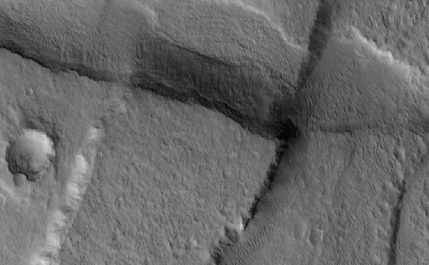 This Mars Global Surveyor (MGS) Mars Orbiter Camera (MOC) image shows cross-cutting fault scarps among graben features in northern Tempe Terra. Graben form in regions where the crust of the planet has been extended; such features are common in the regions surrounding the vast "Tharsis Bulge" on Mars.