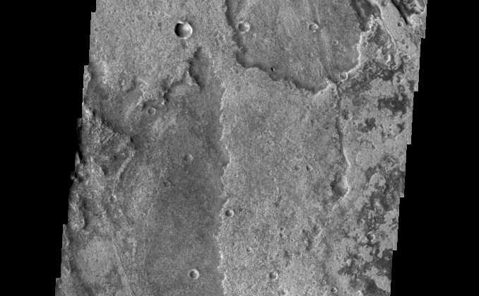 Just as on Earth, volcanism and tectonism are found together on Mars. Here is an example: the ridges and fractures of Claritas Fossae are affecting or perhaps hosting the volcanic flows of Solis Planum.