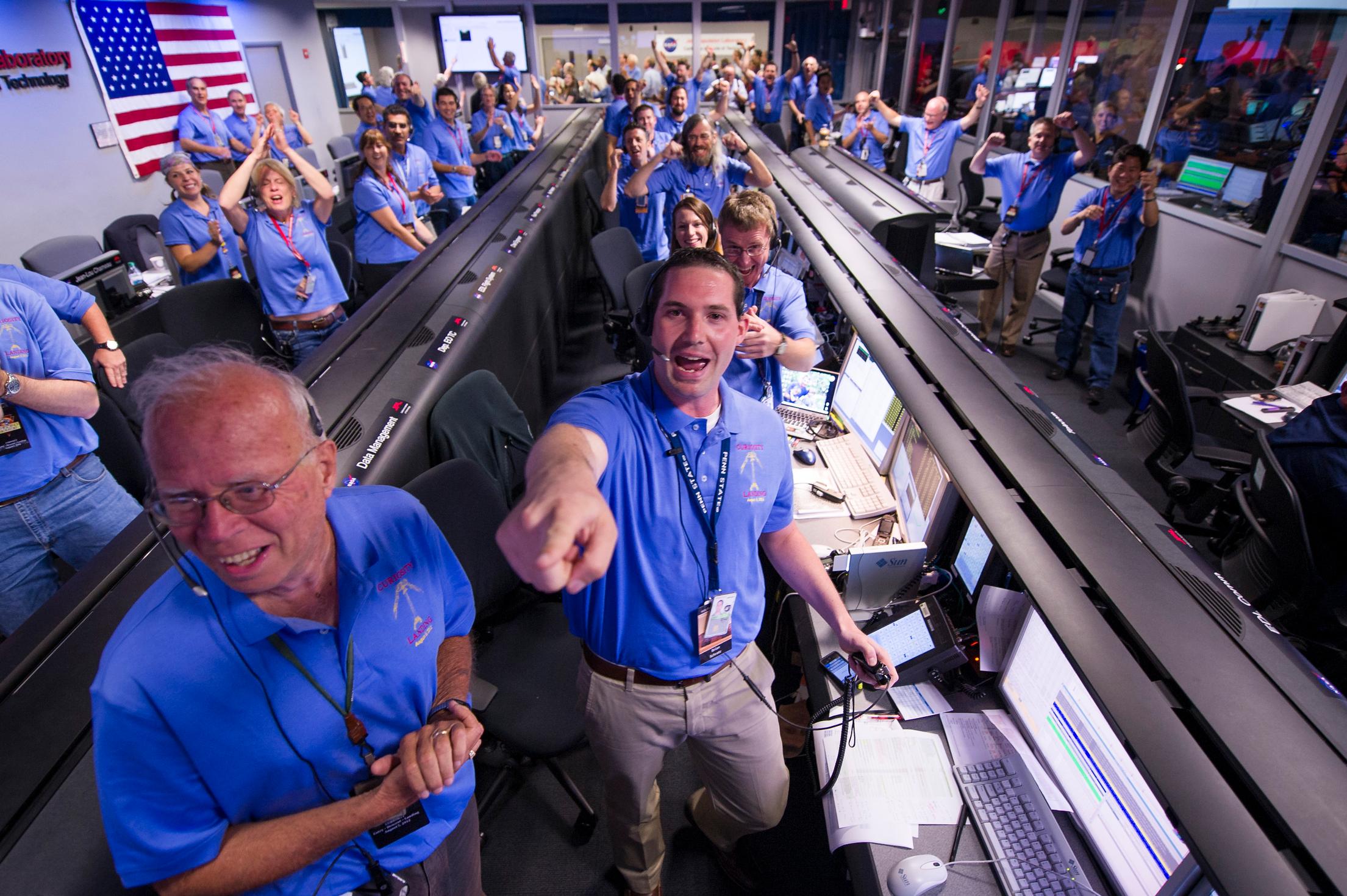 The Mars Science Laboratory (MSL) team in the MSL Mission Support Area react after learning the the Curiosity rove has landed safely on Mars and images start coming in at the Jet Propulsion Laboratory on Mars, Sunday, Aug. 5, 2012 in Pasadena, Calif. The MSL Rover named Curiosity was designed to assess whether Mars ever had an environment able to support small life forms called microbes.