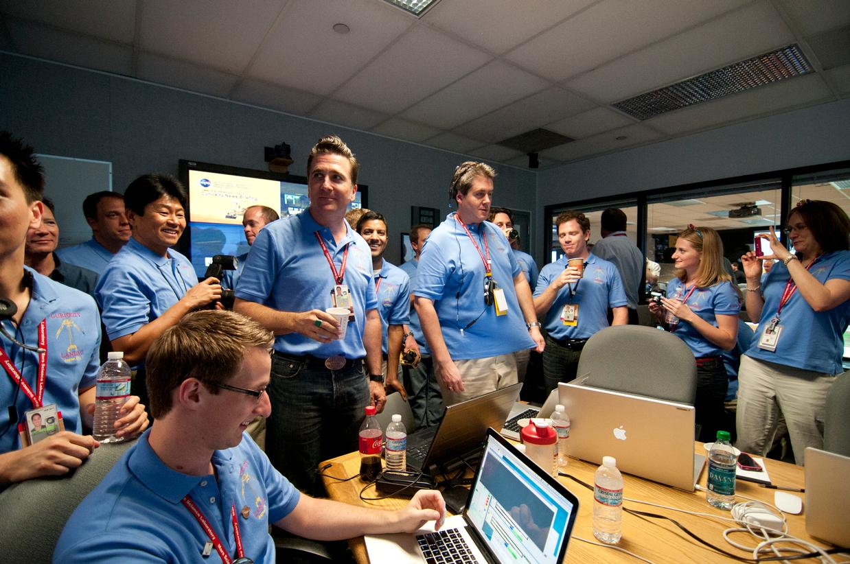 The Entry, Descent and Landing team gathers to celebrate prior to a post-landing press briefing.
