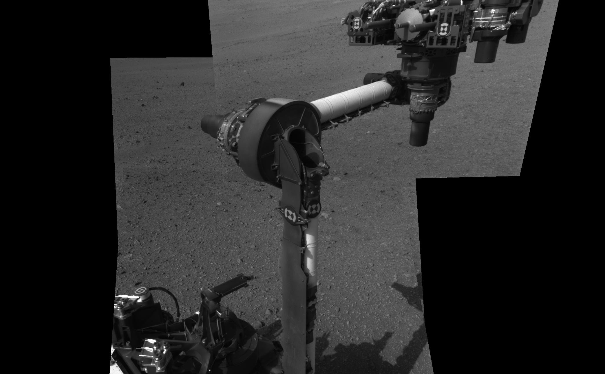 The extended robotic arm of NASA's Mars rover Curiosity can be seen in this mosaic of full-resolution images from Curiosity's Navigation camera (Navcam). Curiosity extended its arm on Aug. 20, 2012.