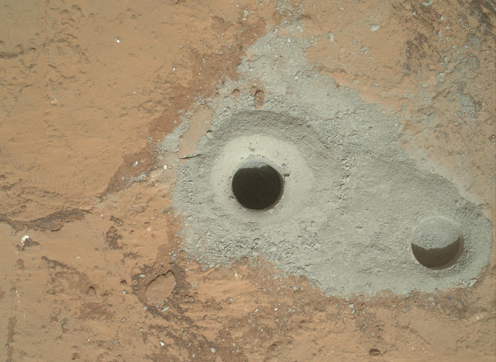 At the center of this image from NASA's Curiosity rover is the hole in a rock called "John Klein" where the rover conducted its first sample drilling on Mars.
