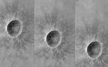 This black-and-white image shows a large crater and small crater on the surface of Mars in three views, in which the craters are in slightly different positions relative to the middle of each of the three frames. It simulates what the camera might see as it moved horizontally through the atmosphere during descent.  A sunflower-petal-like blanket of ejected rocks and soil surround the dark hole of the bright rimmed crater.