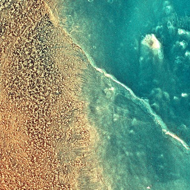 The enhanced-color image taken by the microscopic imager on the Mars Exploration Rover Spirit shows the rock dubbed "Mazatzal" after a portion of its surface was brushed clean by the rover's rock abrasion tool.