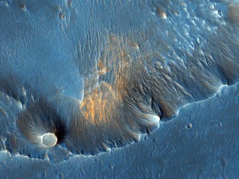 In this HiRISE image taken within Capri Chasma, TES also detected the same crystalline gray hematite like that found at Meridiani Planum.