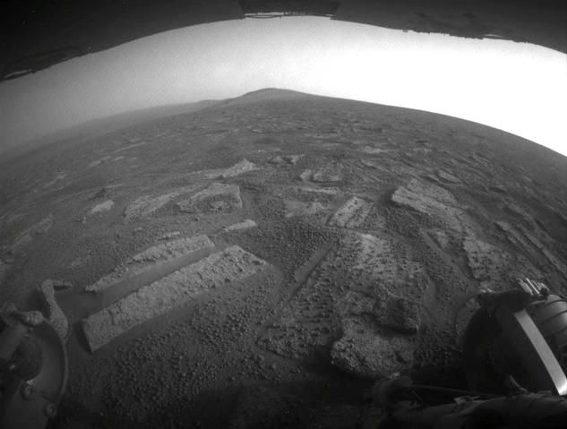 This view shows the terrain that NASA's Mars Exploration Rover Opportunity is crossing in a flat area called "Botany Bay" on the way toward "Solander Point," which is visible on the horizon.