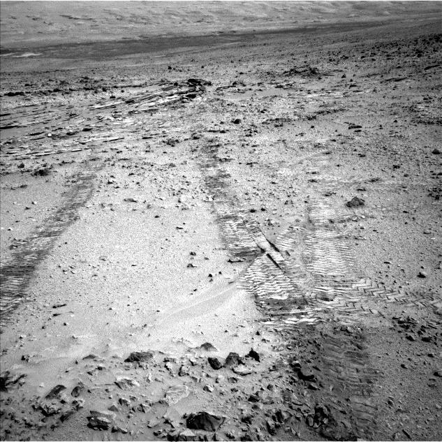 This view from the left Navigation Camera (Navcam) of NASA's Mars Rover Curiosity looks back at wheel tracks made during the first drive away from the last science target in the "Glenelg" area.