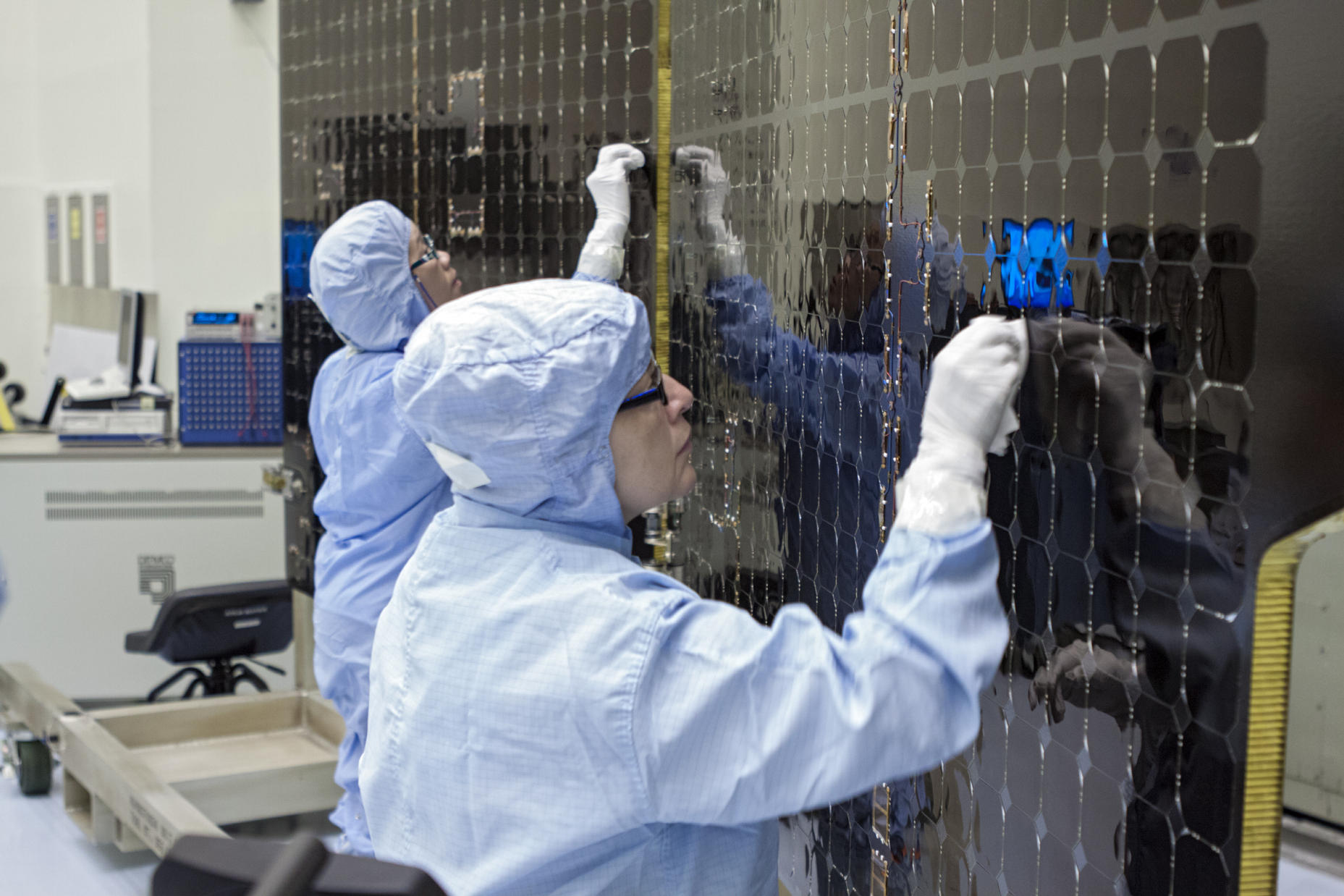 Inside Kennedy's Payload Hazardous Servicing Facility technicians clean the electricity-producing solar arrays for the Mars Atmosphere and Volatile Evolution (MAVEN) spacecraft Aug. 28.