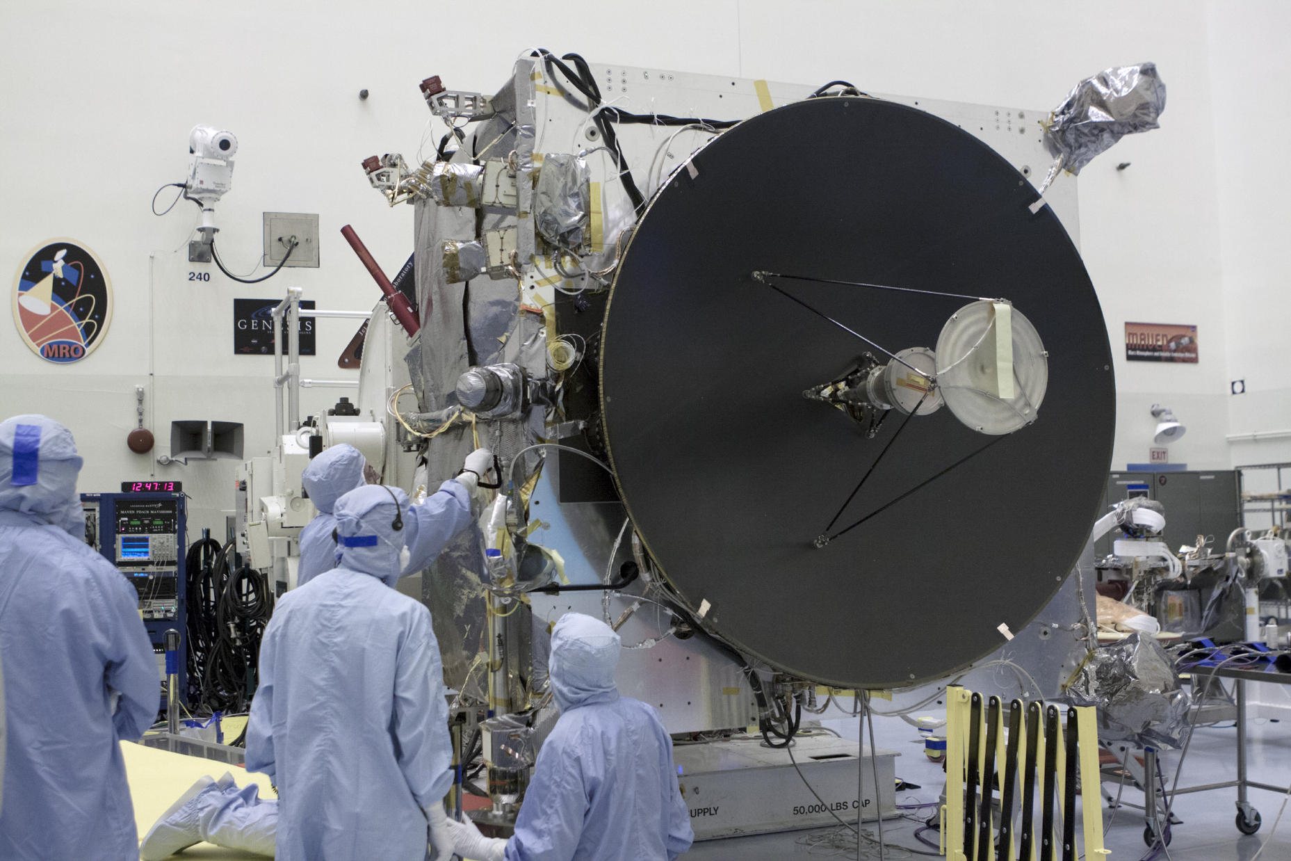Engineers work on the MAVEN spacecraft, which is dominated by the high-gain antenna that is crucial to communications with NASA's Deep Space Network.
