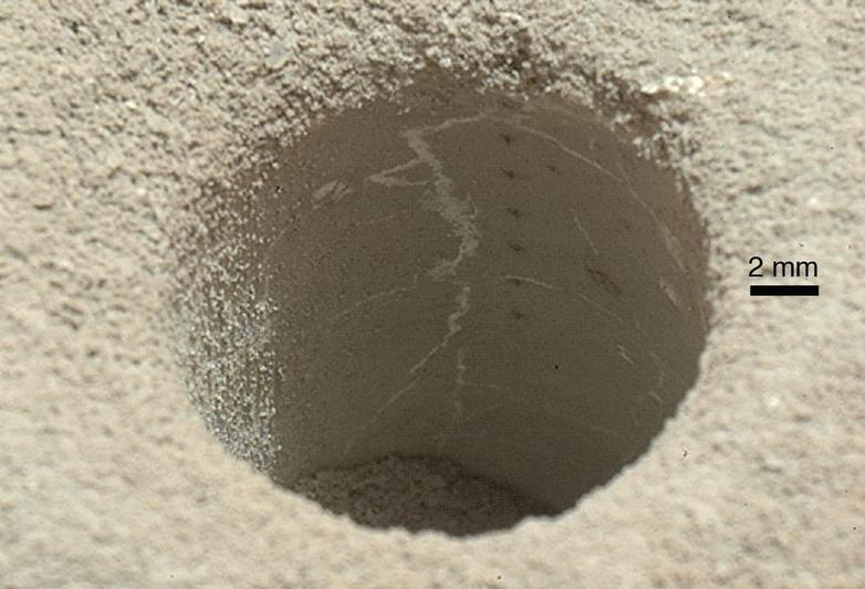 The hole that NASA's Curiosity Mars rover drilled into target rock "John Klein" provided a view into the interior of the rock, as well as obtaining a sample of powdered material from the rock.
